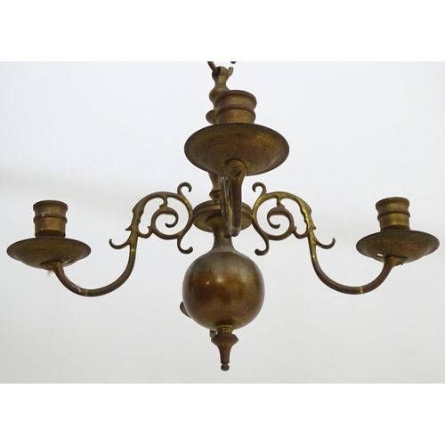 2240 - A pair of Dutch brass pendant chandeliers, the  candle sconces supported on four scrolling branches.... 