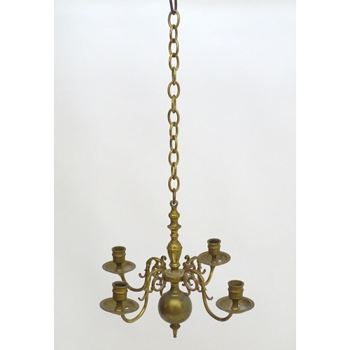 2240 - A pair of Dutch brass pendant chandeliers, the  candle sconces supported on four scrolling branches.... 