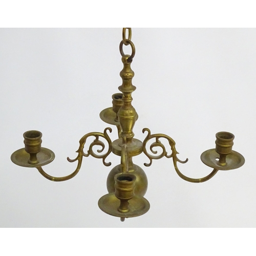 2240 - A pair of Dutch brass pendant chandeliers, the  candle sconces supported on four scrolling branches.... 