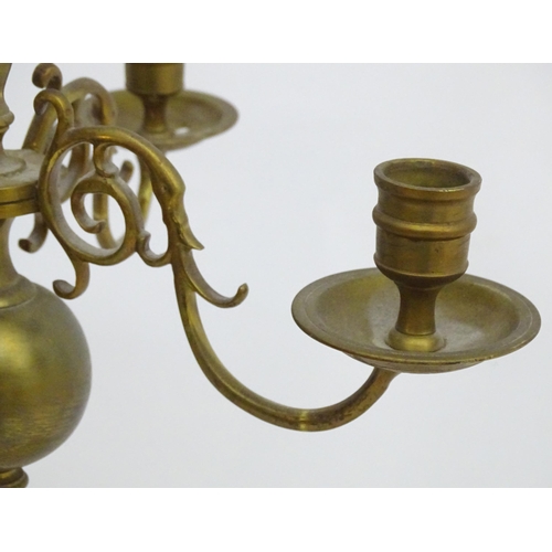 2240 - A pair of Dutch brass pendant chandeliers, the  candle sconces supported on four scrolling branches.... 