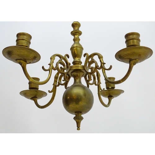 2240 - A pair of Dutch brass pendant chandeliers, the  candle sconces supported on four scrolling branches.... 