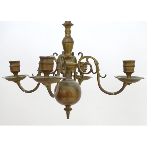 2240 - A pair of Dutch brass pendant chandeliers, the  candle sconces supported on four scrolling branches.... 