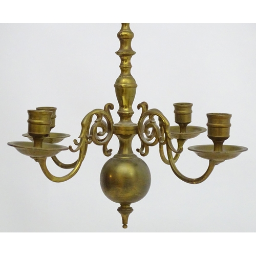 2240 - A pair of Dutch brass pendant chandeliers, the  candle sconces supported on four scrolling branches.... 