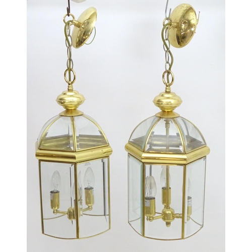 2241 - A set of 4 late 20thC pendant lights, the three branch lights hexagonal formed lantern shades with b... 