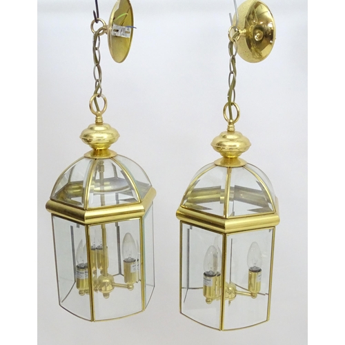 2241 - A set of 4 late 20thC pendant lights, the three branch lights hexagonal formed lantern shades with b... 