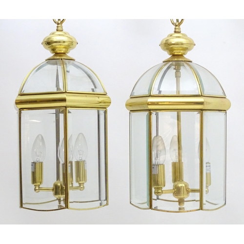 2241 - A set of 4 late 20thC pendant lights, the three branch lights hexagonal formed lantern shades with b... 