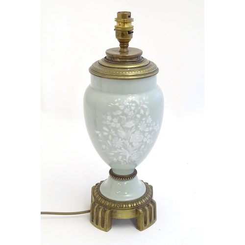 2252 - A Victorian table lamp, the celadon coloured porcelain body with Pate sur Pate floral and foliate de... 