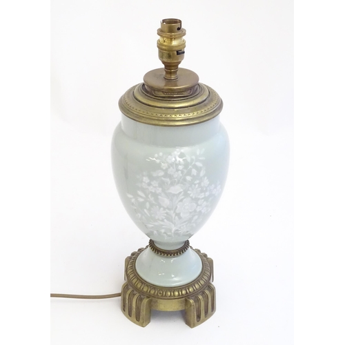 2252 - A Victorian table lamp, the celadon coloured porcelain body with Pate sur Pate floral and foliate de... 