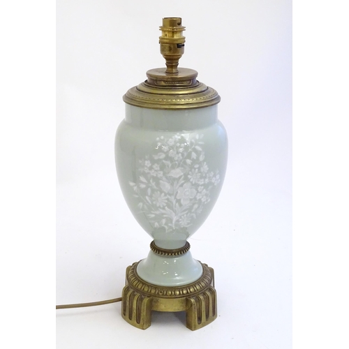 2252 - A Victorian table lamp, the celadon coloured porcelain body with Pate sur Pate floral and foliate de... 