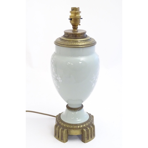 2252 - A Victorian table lamp, the celadon coloured porcelain body with Pate sur Pate floral and foliate de... 