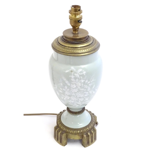 2252 - A Victorian table lamp, the celadon coloured porcelain body with Pate sur Pate floral and foliate de... 