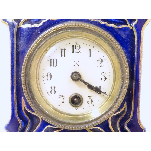 2286 - A Jugendstil mantle clock formed as a ceramic cased long case clock with blue and gilt detail. the d... 