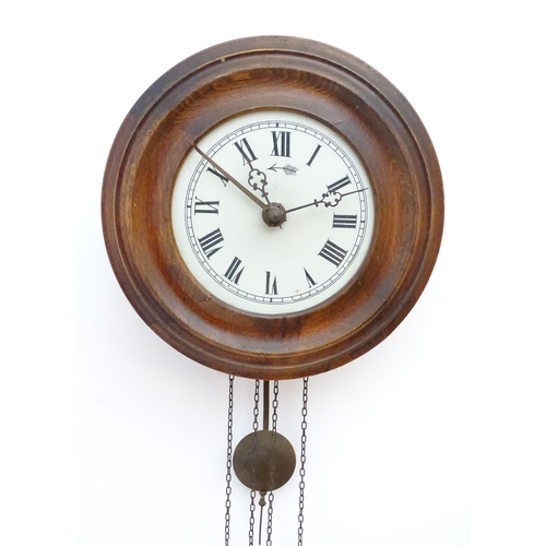 2287A - A postmans alarm style wall clock  with cast black forest style pine cone weights. The movement surm... 