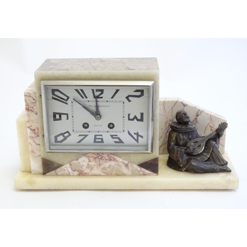 2288 - An Art Deco onyx and marble mantle clock with cased figure of seated Pierrot. The clock dial signed ... 