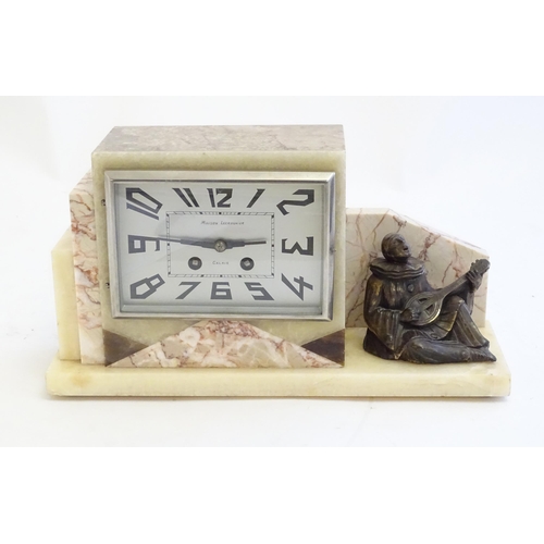 2288 - An Art Deco onyx and marble mantle clock with cased figure of seated Pierrot. The clock dial signed ... 