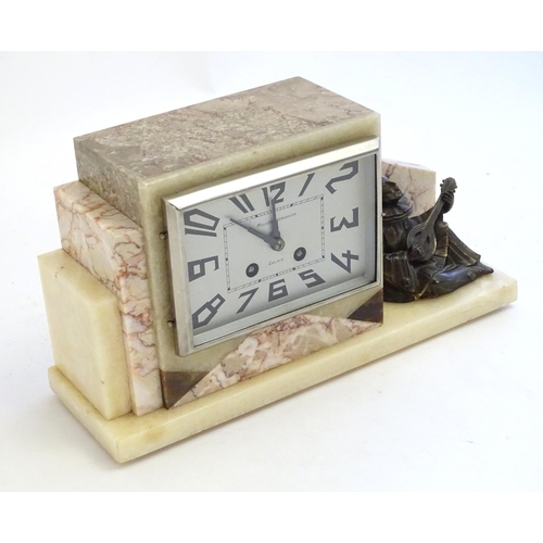 2288 - An Art Deco onyx and marble mantle clock with cased figure of seated Pierrot. The clock dial signed ... 