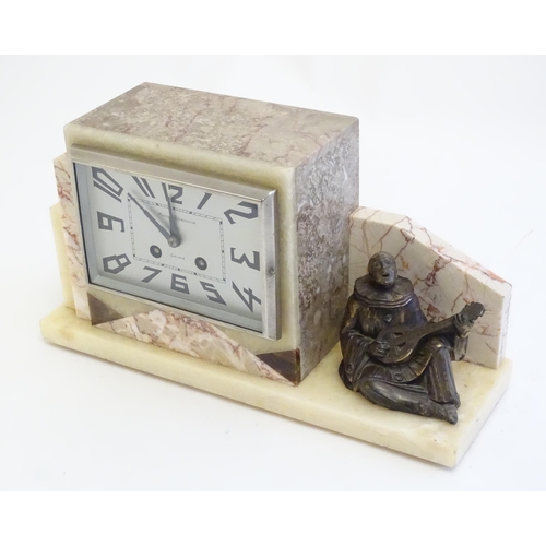 2288 - An Art Deco onyx and marble mantle clock with cased figure of seated Pierrot. The clock dial signed ... 