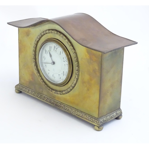 2293 - A mantle clock by Japy freres the shaped brass case with enamel dial marked signed Japy freres mark.... 