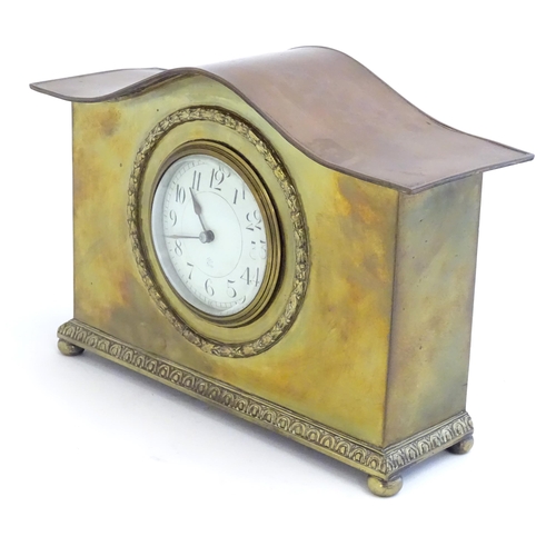 2293 - A mantle clock by Japy freres the shaped brass case with enamel dial marked signed Japy freres mark.... 