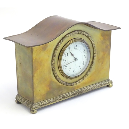 2293 - A mantle clock by Japy freres the shaped brass case with enamel dial marked signed Japy freres mark.... 