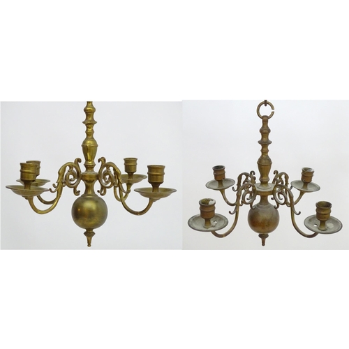 2240 - A pair of Dutch brass pendant chandeliers, the  candle sconces supported on four scrolling branches.... 