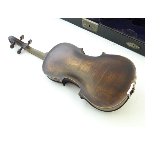 1540 - Musical Instruments: a 19thC German violin, of stained maple construction with carved lion's head sc... 