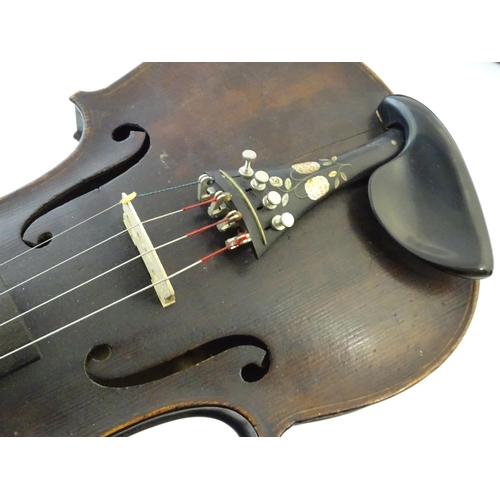 1540 - Musical Instruments: a 19thC German violin, of stained maple construction with carved lion's head sc... 