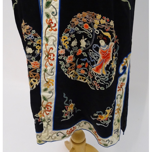 1548 - A Chinese informal coat, the black ground embroidered with Peking knot stitch decorative roundels de... 