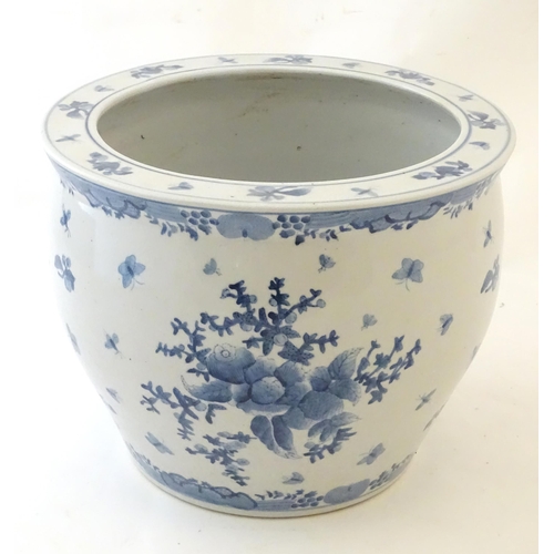 69 - A Chinese blue and white planter / jardiniere decorated with flowers, foliage, insects, fruit and bu... 