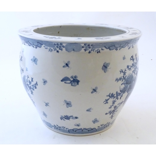 69 - A Chinese blue and white planter / jardiniere decorated with flowers, foliage, insects, fruit and bu... 