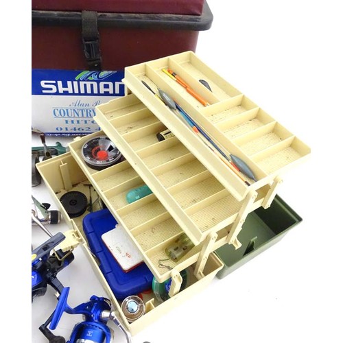 Fishing: a Shimano fishing seat box containing a collection of fixed spool  fishing reels, comprising