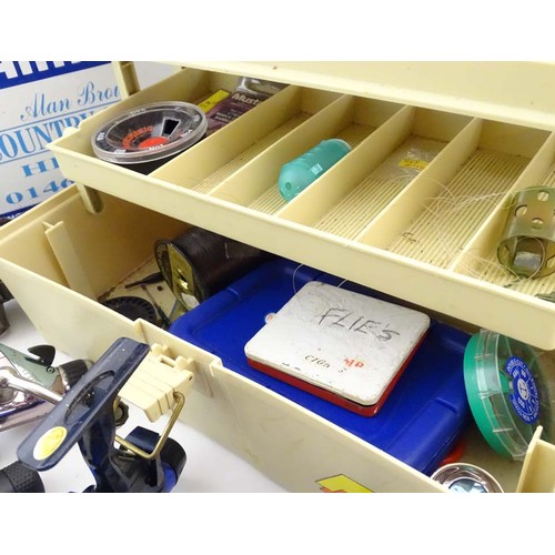 Fishing: a Shimano fishing seat box containing a collection of fixed spool  fishing reels, comprising