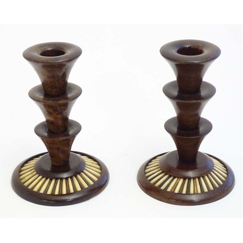 1166 - A pair of 20thC treen candlesticks with stepped columns and porcupine quill detail to base. Approx. ... 