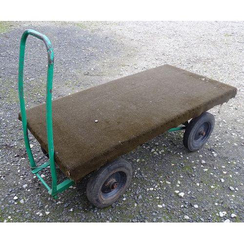 1113 - A grocer's barrow / trolley, the steel frame with four wheels, steering handle and solid platform. T... 