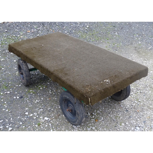 1113 - A grocer's barrow / trolley, the steel frame with four wheels, steering handle and solid platform. T... 