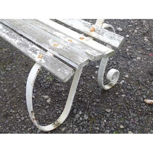 1121 - A Victorian garden bench with wrought iron mounts and wooden slatted seat, white painted finish, tog... 