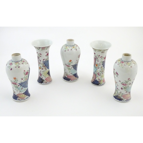 12 - Five Chinese famille rose vases comprising two trumpet vases with floral and foliate detail, and thr... 