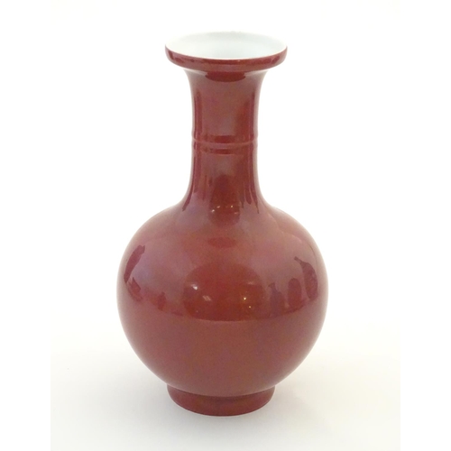 33 - A Chinese bottle vase with a flared rim. Character marks under. Approx. 7 3/4