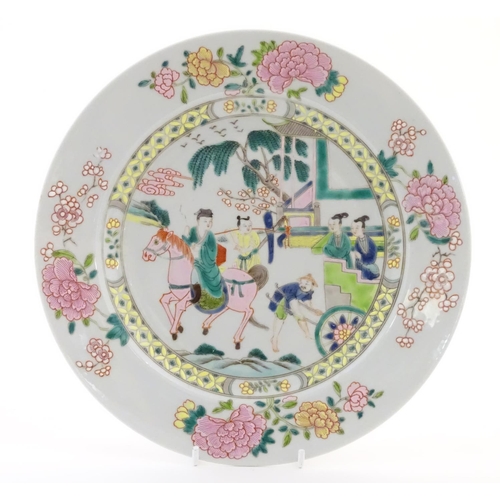 40 - A Chinese famille rose plate depicting a landscape scene with a figure on horse back with an attenda... 