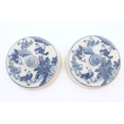 58 - Two Chinese blue and white lids with figures in a landscape. Approx. 6 1/2