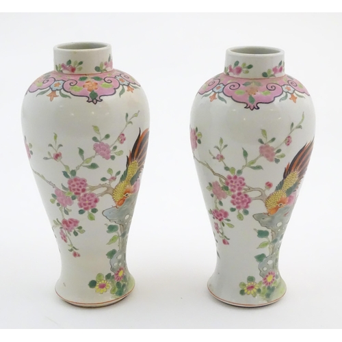 65 - A pair of Chinese famille rose baluster vases decorated with two cockerels / rooster amongst flowers... 