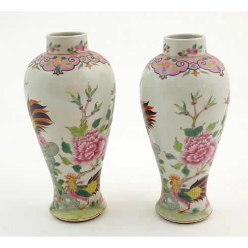 65 - A pair of Chinese famille rose baluster vases decorated with two cockerels / rooster amongst flowers... 