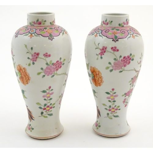 65 - A pair of Chinese famille rose baluster vases decorated with two cockerels / rooster amongst flowers... 