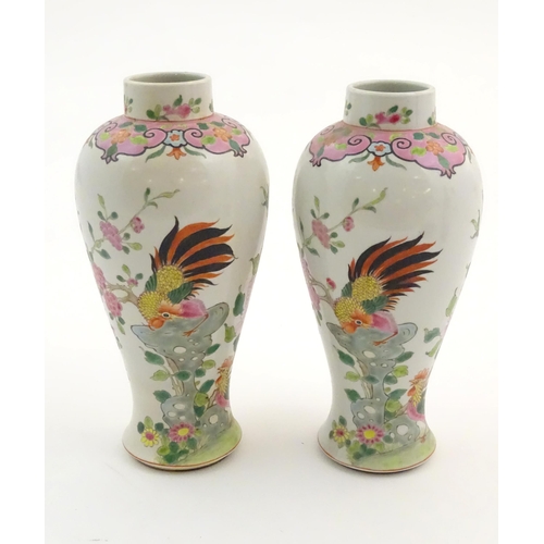 65 - A pair of Chinese famille rose baluster vases decorated with two cockerels / rooster amongst flowers... 