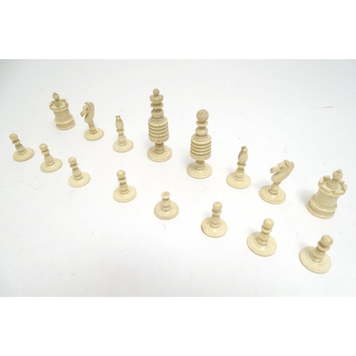 1307 - Toys: A 19thC / early 20thC set of turned and carved bone chess pieces, the largest approx. 4