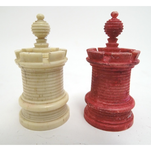 1307 - Toys: A 19thC / early 20thC set of turned and carved bone chess pieces, the largest approx. 4