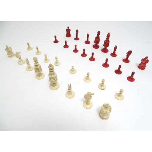 1307 - Toys: A 19thC / early 20thC set of turned and carved bone chess pieces, the largest approx. 4