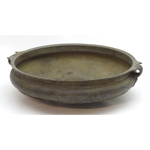 1352 - A 19thC large bronze basin / planter of circular form with twin handles and relief stylised heart de... 