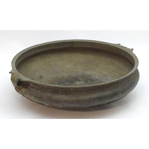 1352 - A 19thC large bronze basin / planter of circular form with twin handles and relief stylised heart de... 