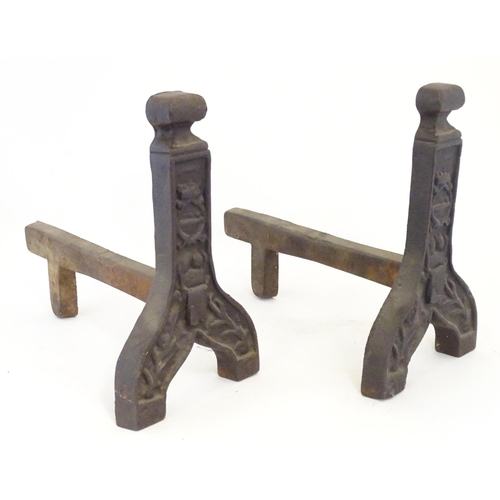 1359 - A pair of 19thC cast iron fire dogs / andirons with foliate and cartouche detail. Approx. 16 1/4